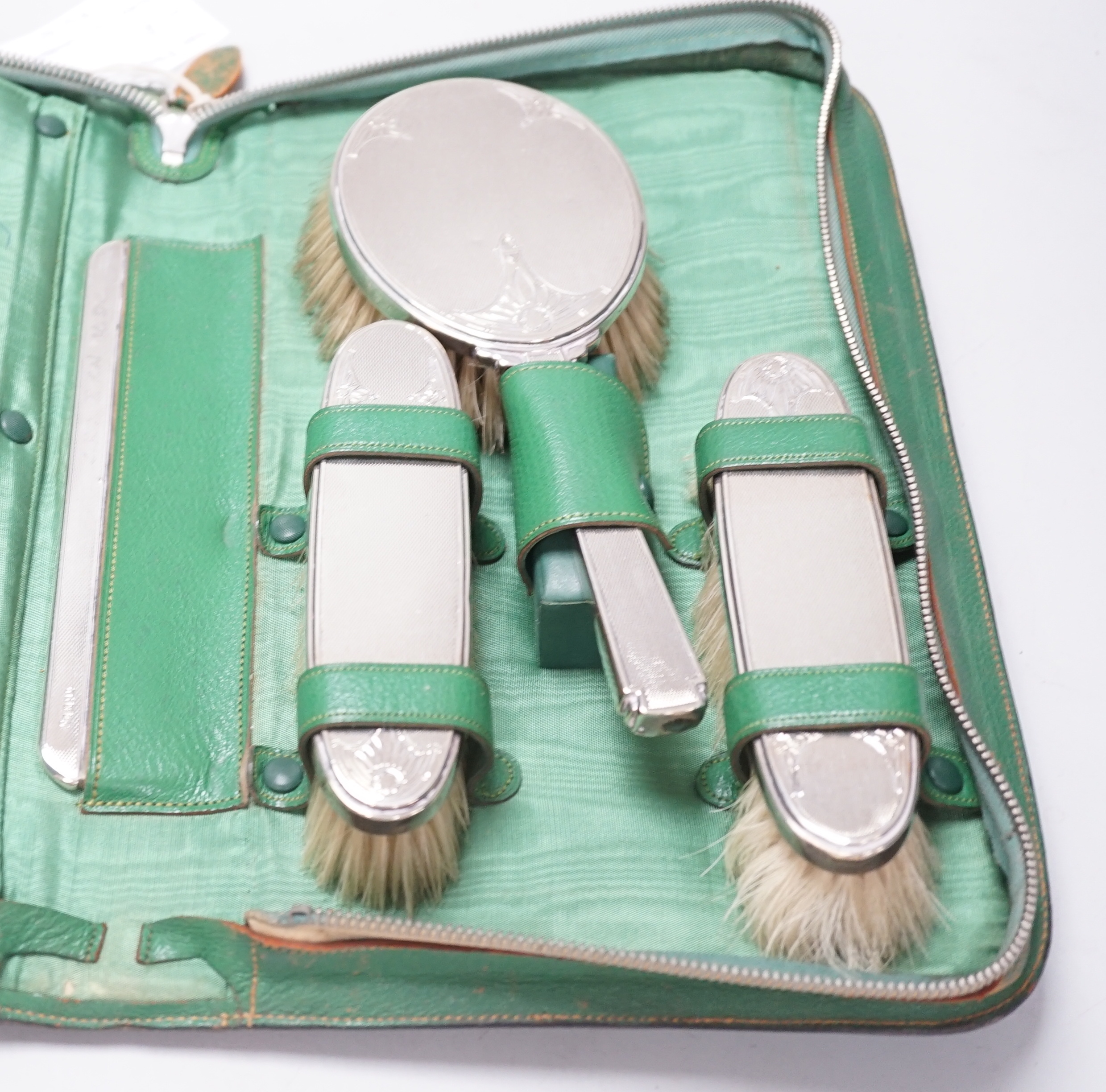 A cased George V five piece silver mounted mirror, brush and comb set, William Comyns & Sons Ltd, London, 1935.